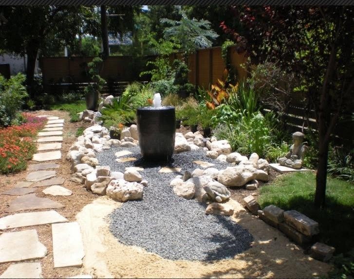 Serene custom garden with a Zen water feature and native rock garden